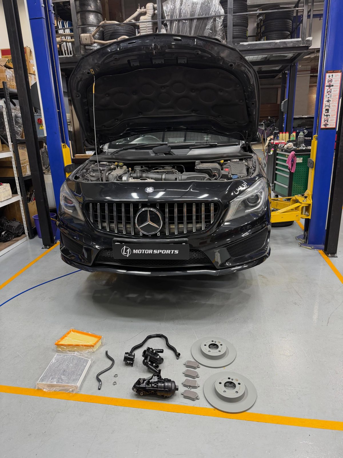 Inside the L1 Motorsports workshop, a Mercedes on the lift